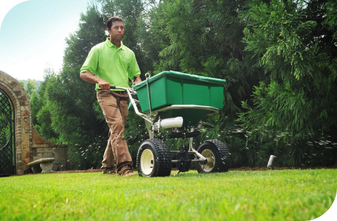 Waynes_Pest_Lawn Fertilizer Services_man-pushing-fertilizer